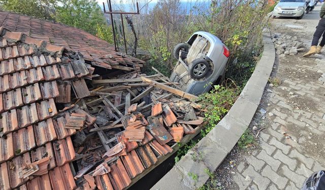 Kontrolden çıkan otomobil kullanılmayan evin çatısına düştü
